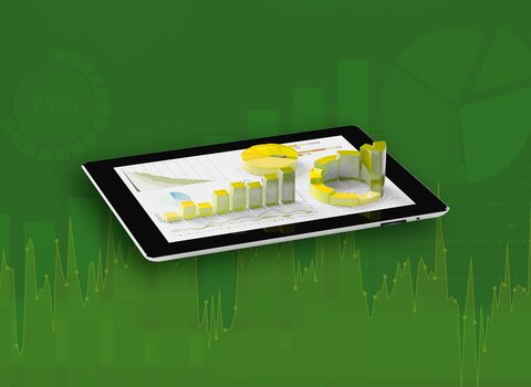 You can see a tablet from which various pie charts and bar charts grow upwards in a three-dimensional representation. The diagrams on the tablet are coloured yellow and green. The background behind the tablet is also green and shows two-dimensional graphs. | © wob AG